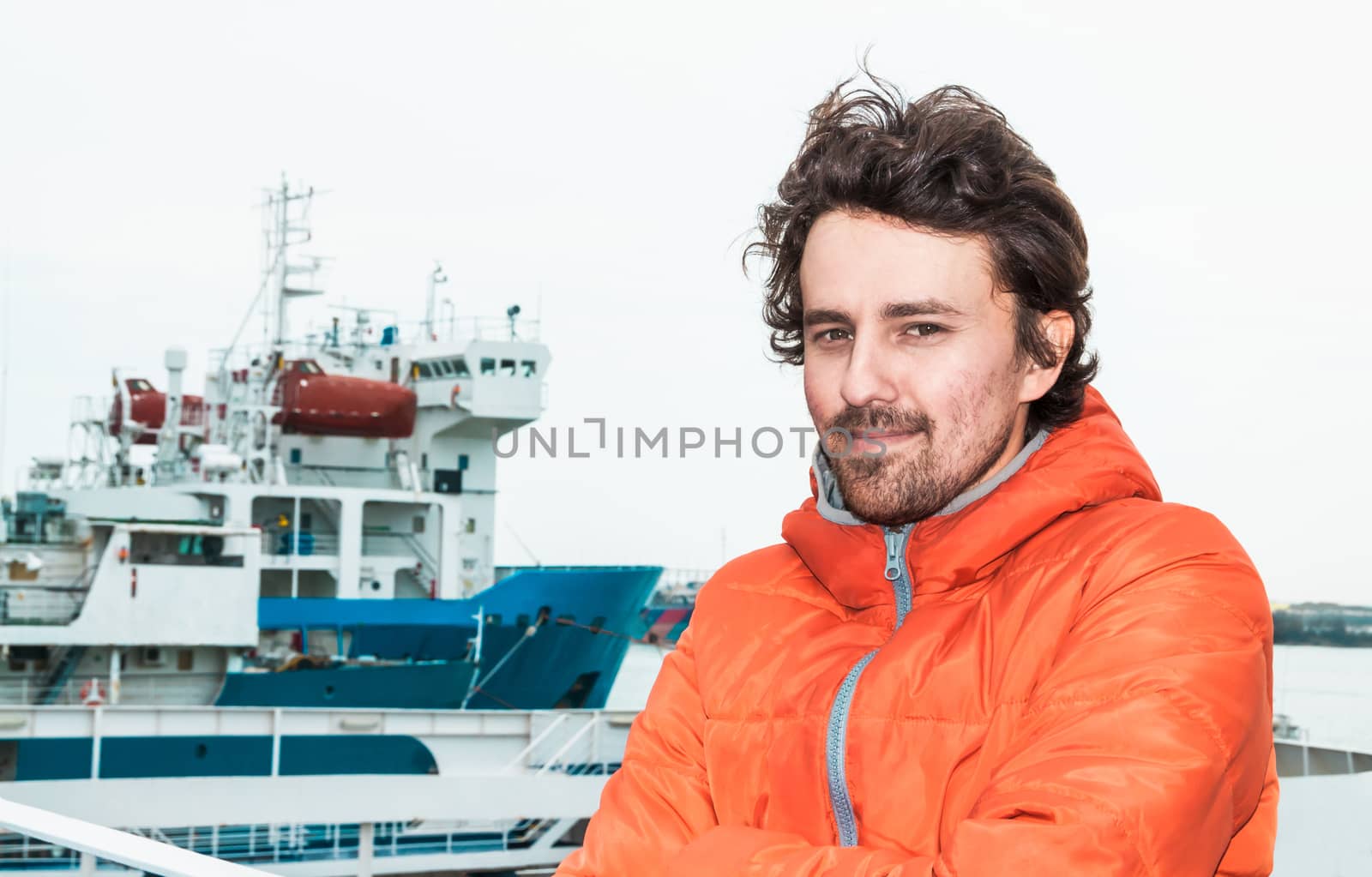 Portrait of a young successful man on the background sea landscape.