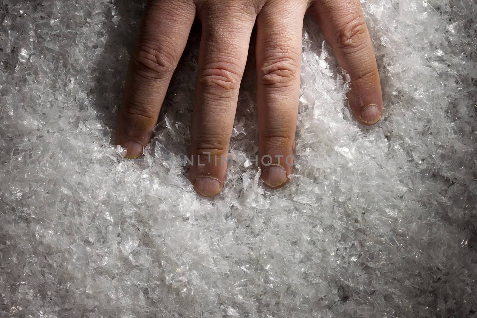Hand of a man in white artificial snow