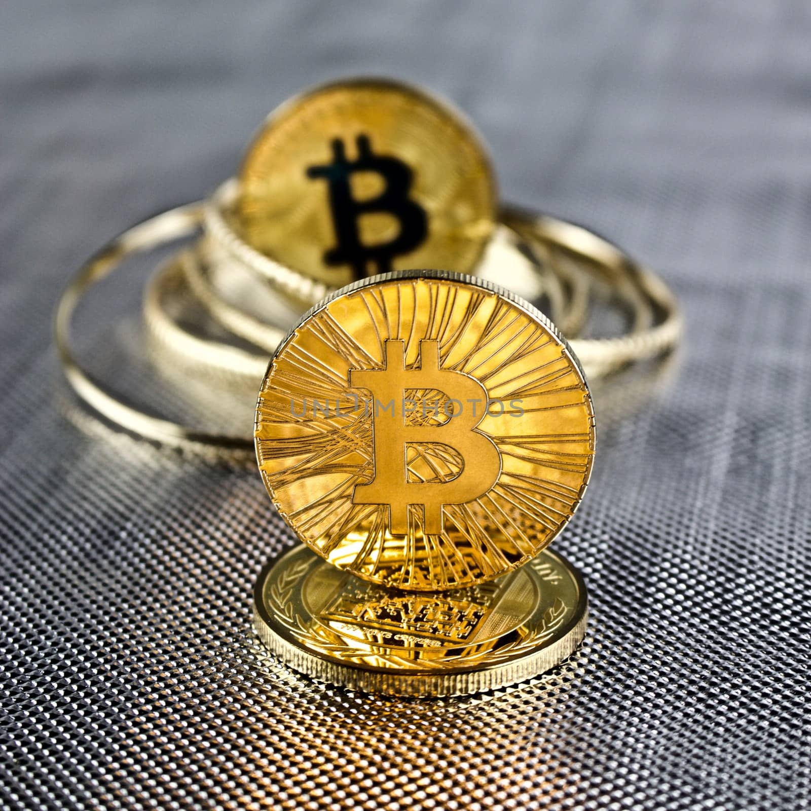 Digital currency physical gold bitcoin coins. Silver background concept.