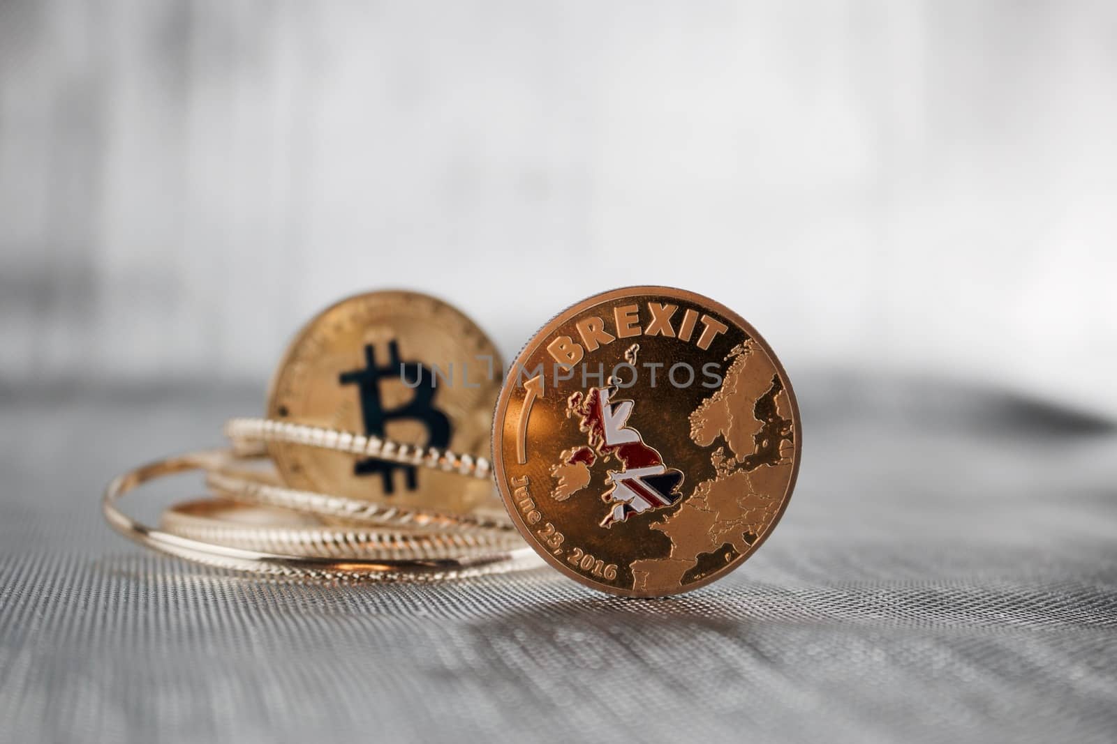 Cryptocurrency physical bitcoin coin and gold brexit coin. Europe leaving.