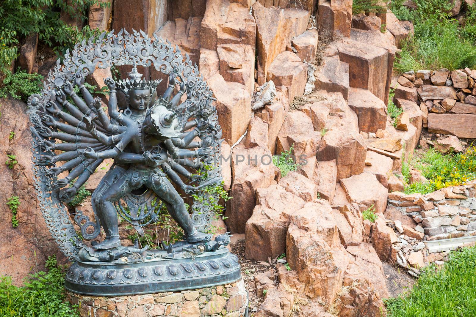 Tantric Deities statue in Ritual Embrace located in a mountain g by Perseomedusa