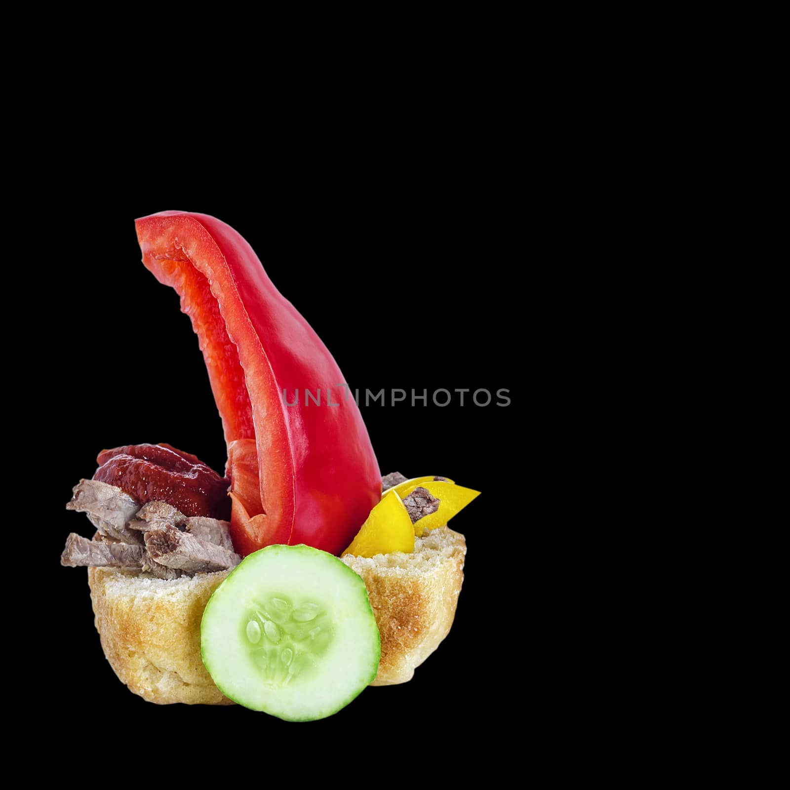 Sandwich with meat and vegetables, and ketchup on a black background. In the form of a boat for kids.