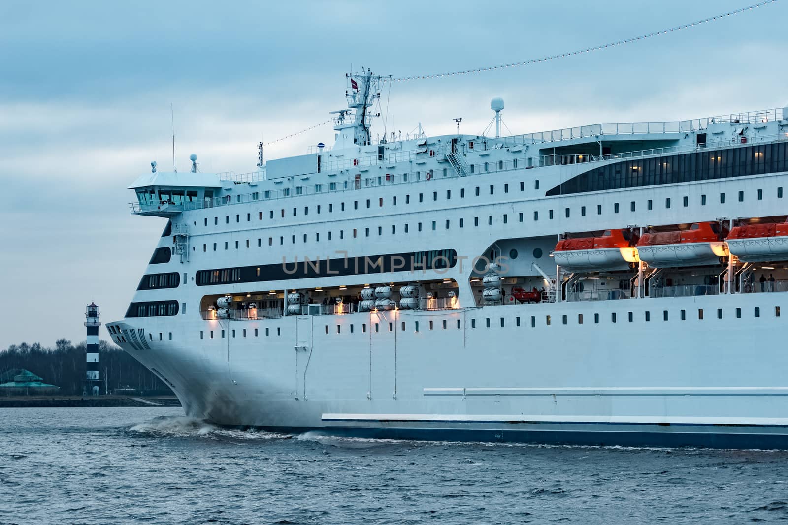 White cruise liner. Passenger ferry moving in still water
