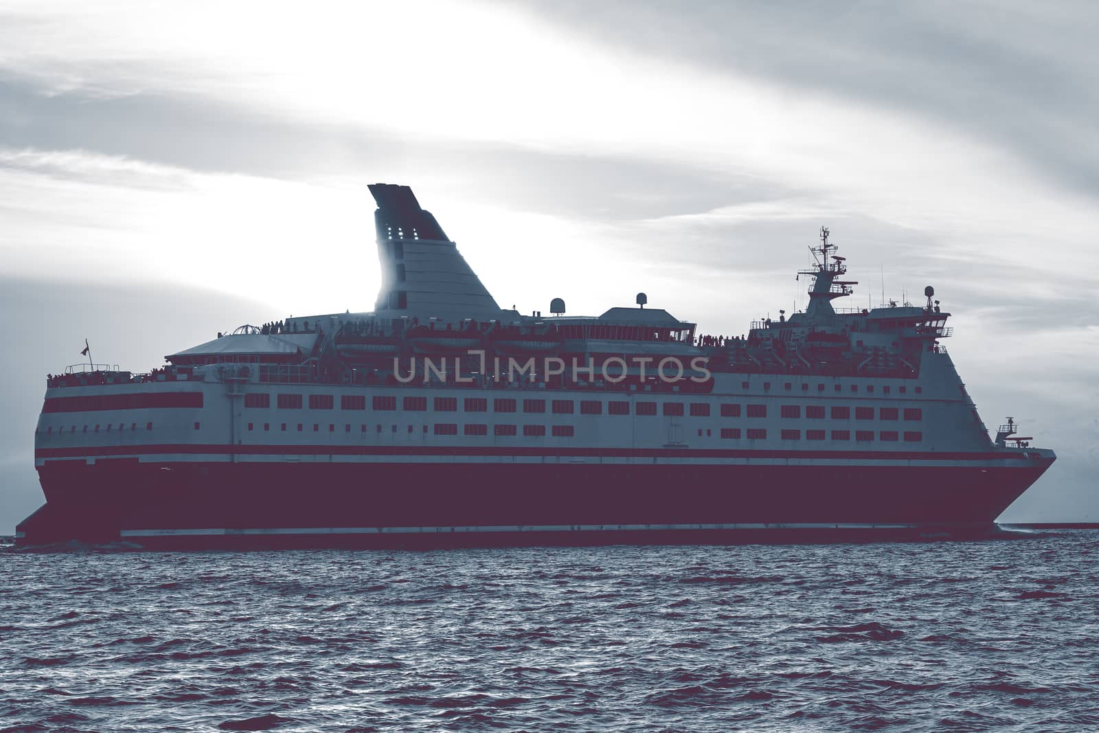 Cruise liner leaving Riga. Passenger ferry sailing at hot sunset