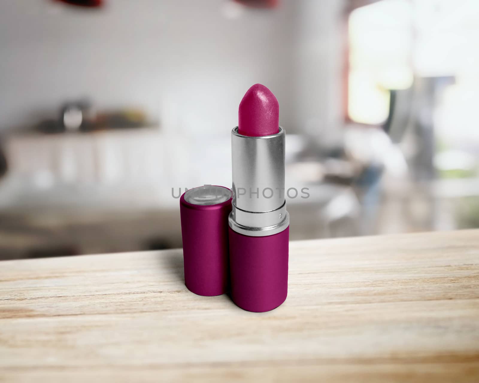 lipstick closeup on wooden table by boys1983@mail.ru