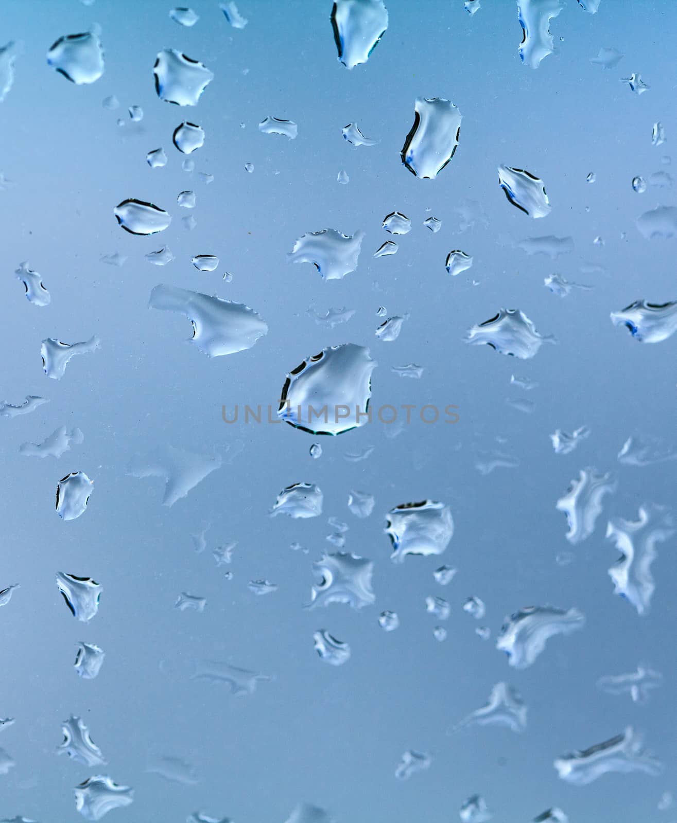 Closeup shot of water drops on the glass