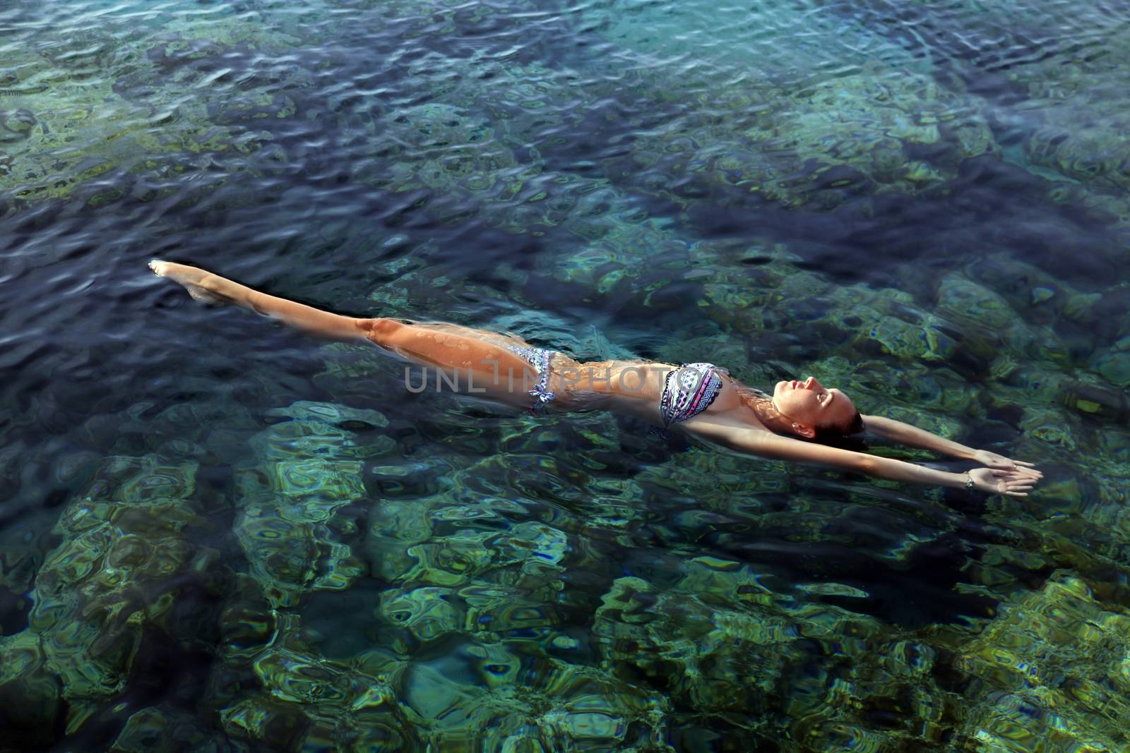 Woman Floating in Water Relaxing by friday