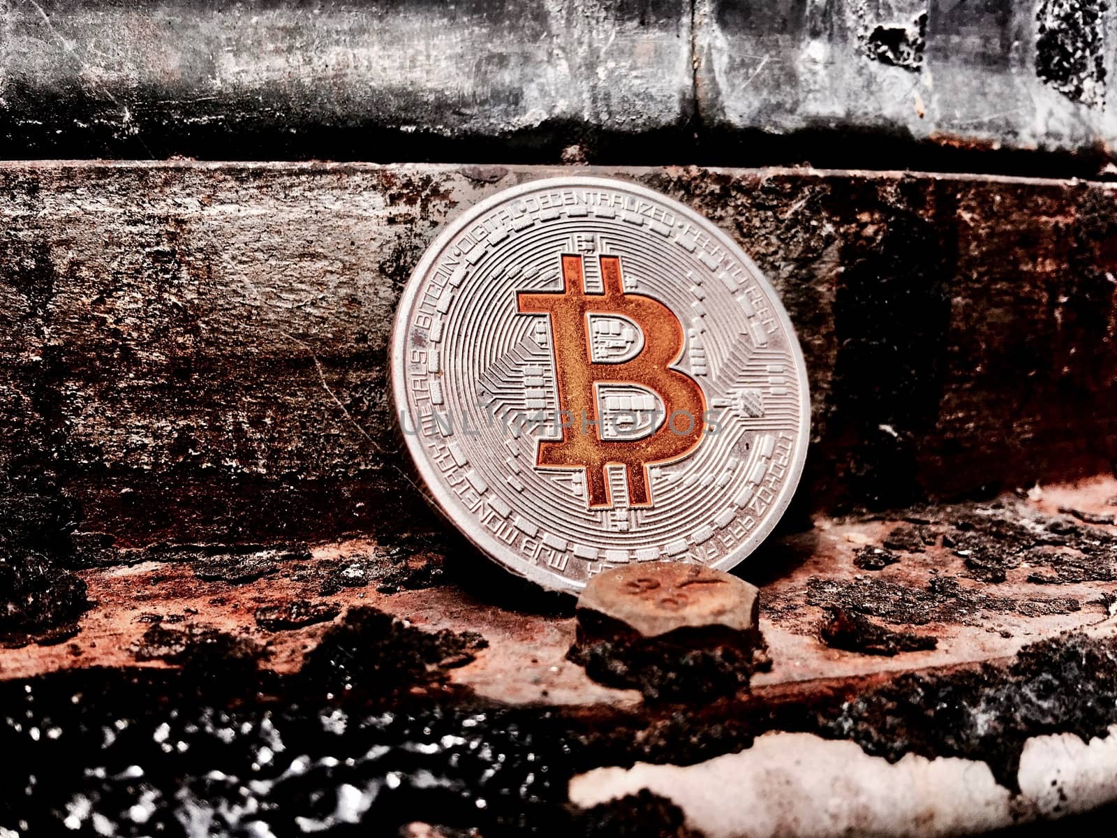Cryptocurrency physical silver bitcoin coin in old industry.