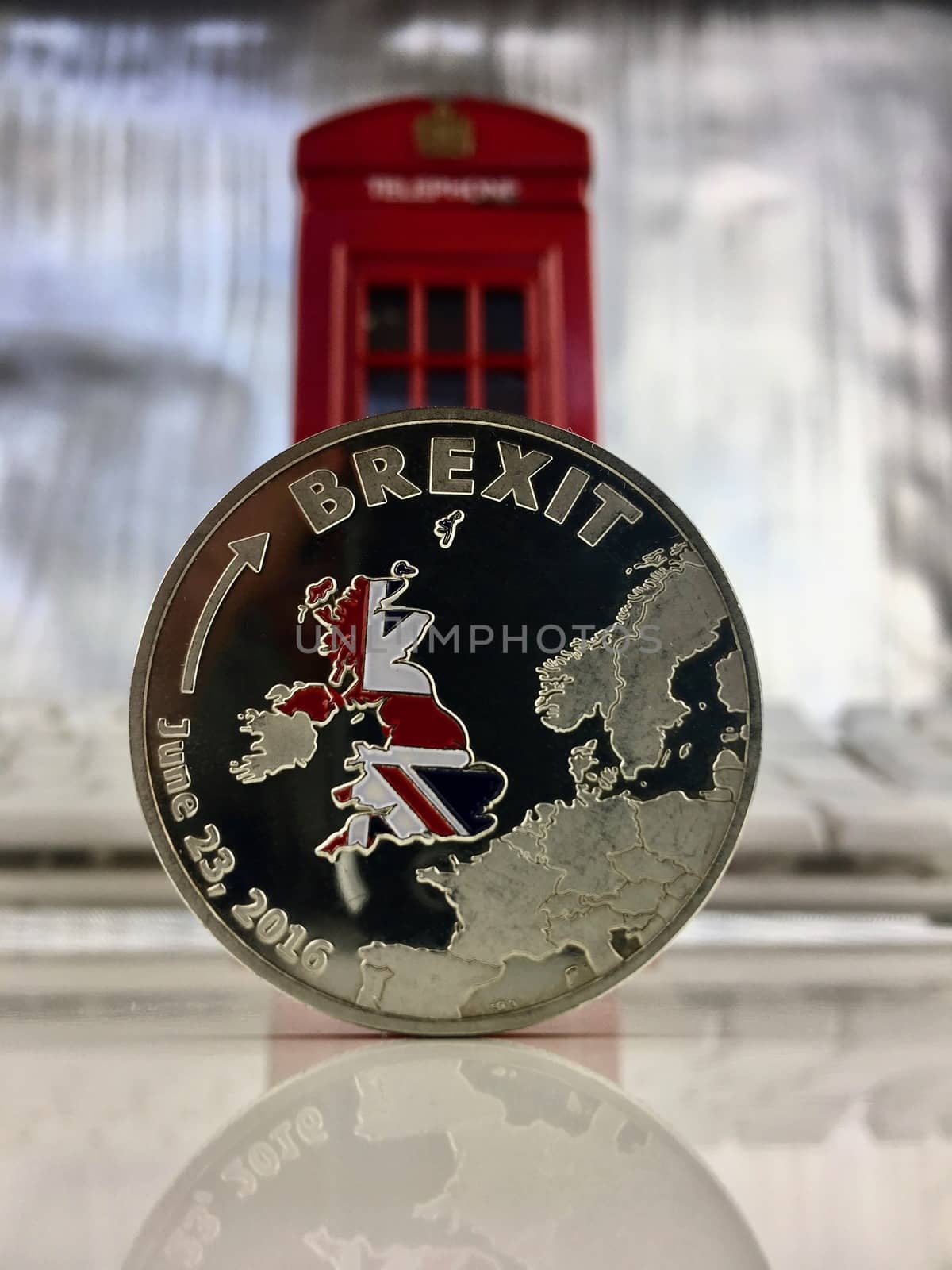 Physical silver brexit coin with a british flag. Europe leaving.