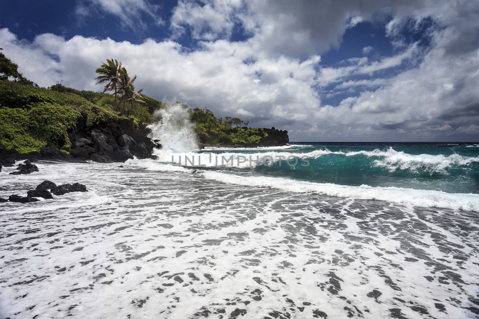 This is an image of Waianapanapa State Park, located in Hana on the island of Maui, Hawaii. Below is one of the parks most beautiful beaches.