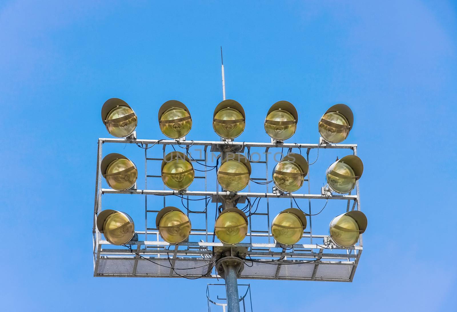 metal stadium lights for sport field with blue sky in background