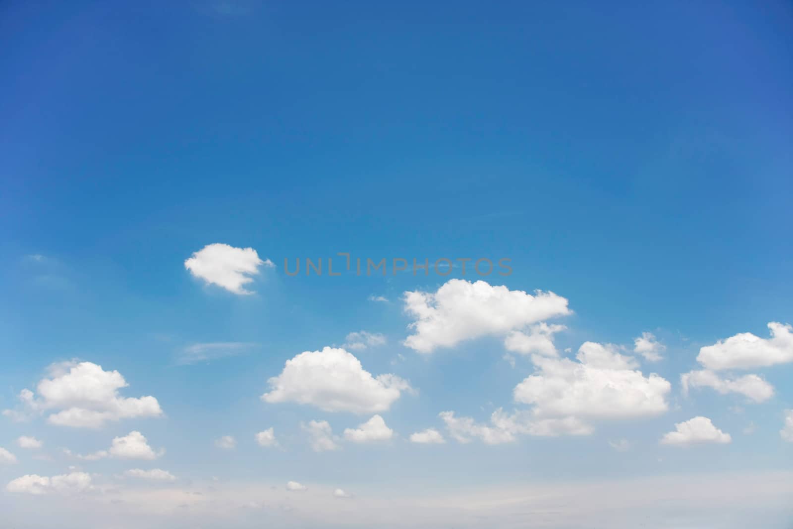 white clouds with blue sky on bright day