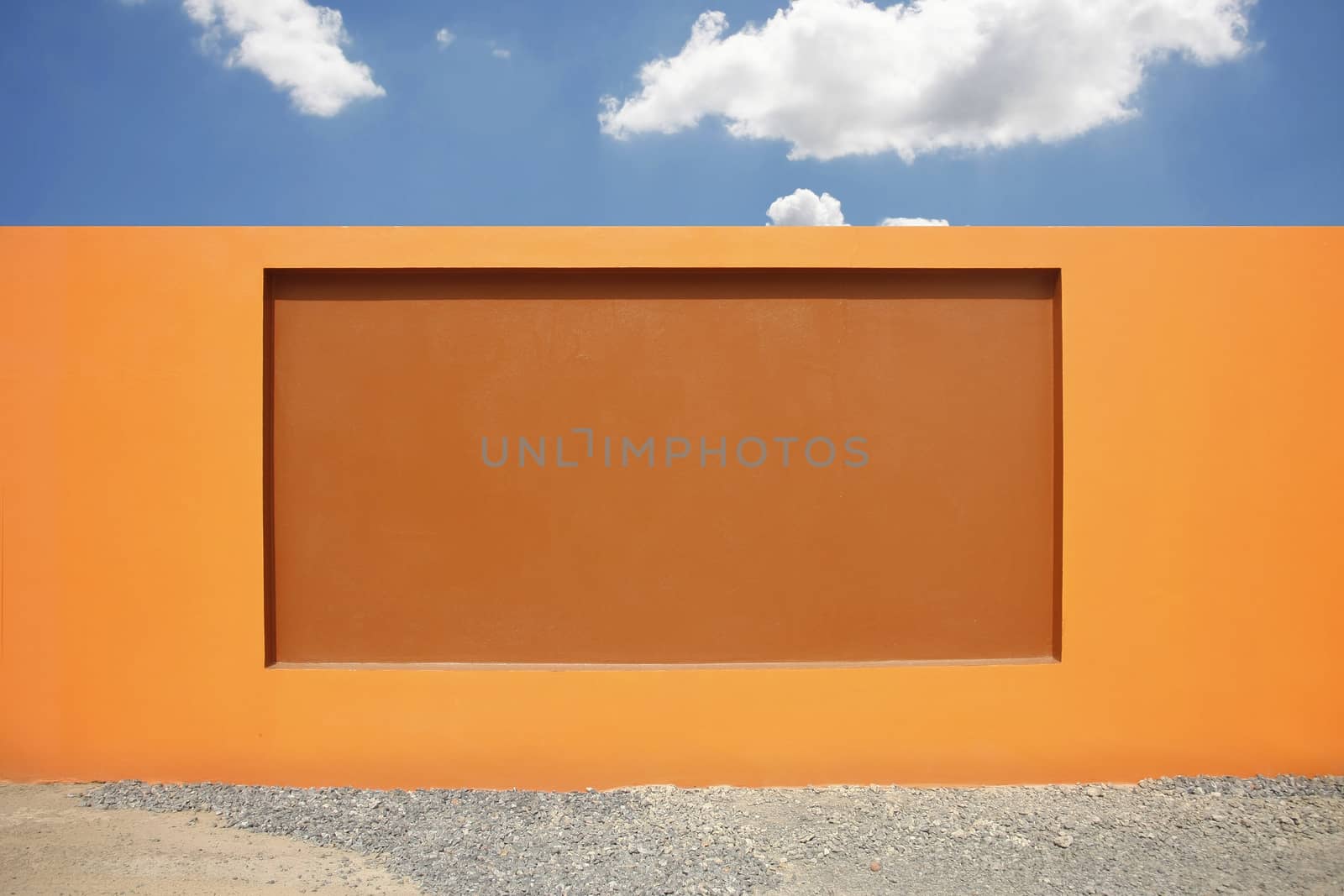 beautiful orange wall, modern cement fence with rocks floor and white background