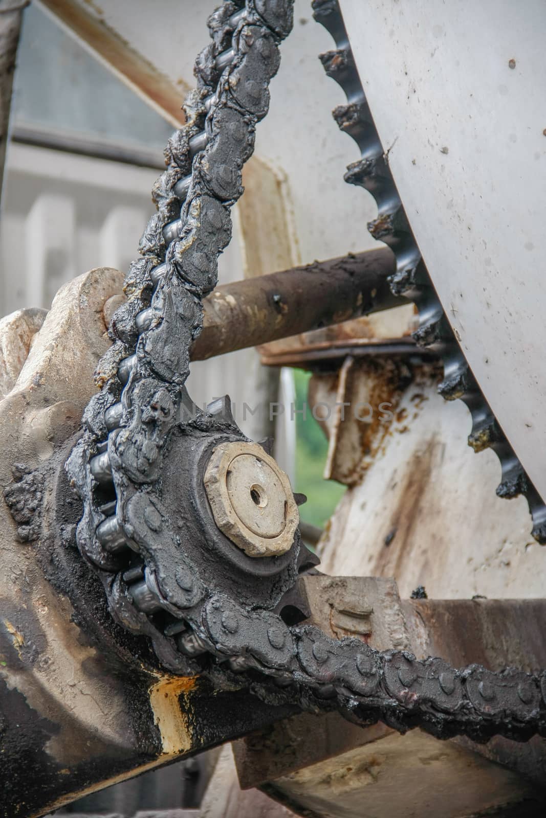 old chain with grease on propel roller for motor powered