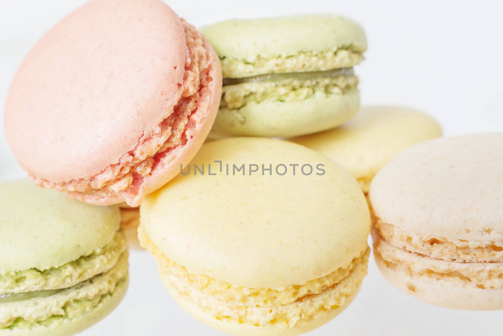 Several multicolored macaroons pastel colors isolated on white background