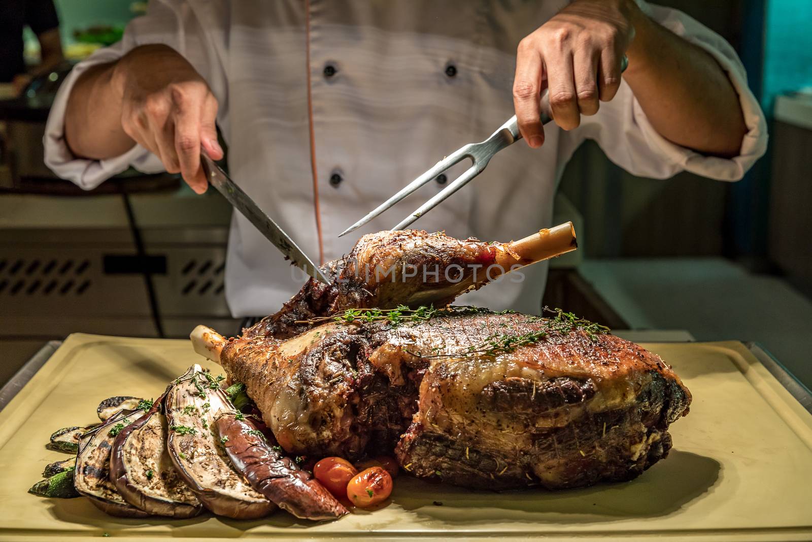 Carving of Roasted lamb meat