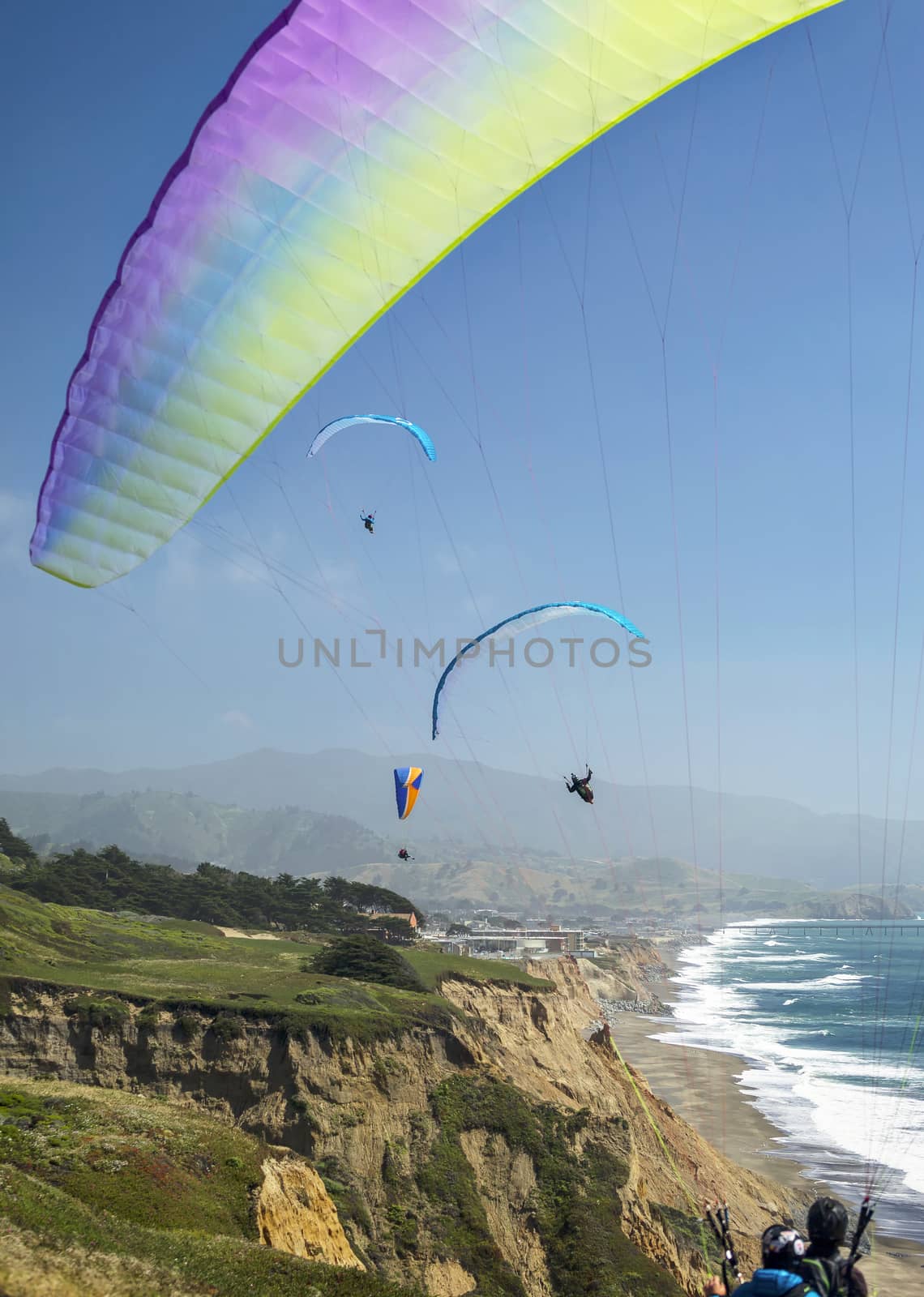 This is an image of a paraglider over Muscle Beach along California’s central coast.  Muscle beach is located in Pacifica, California, which is a prime spot for paragliding due to its fantastic weather conditions and views. 