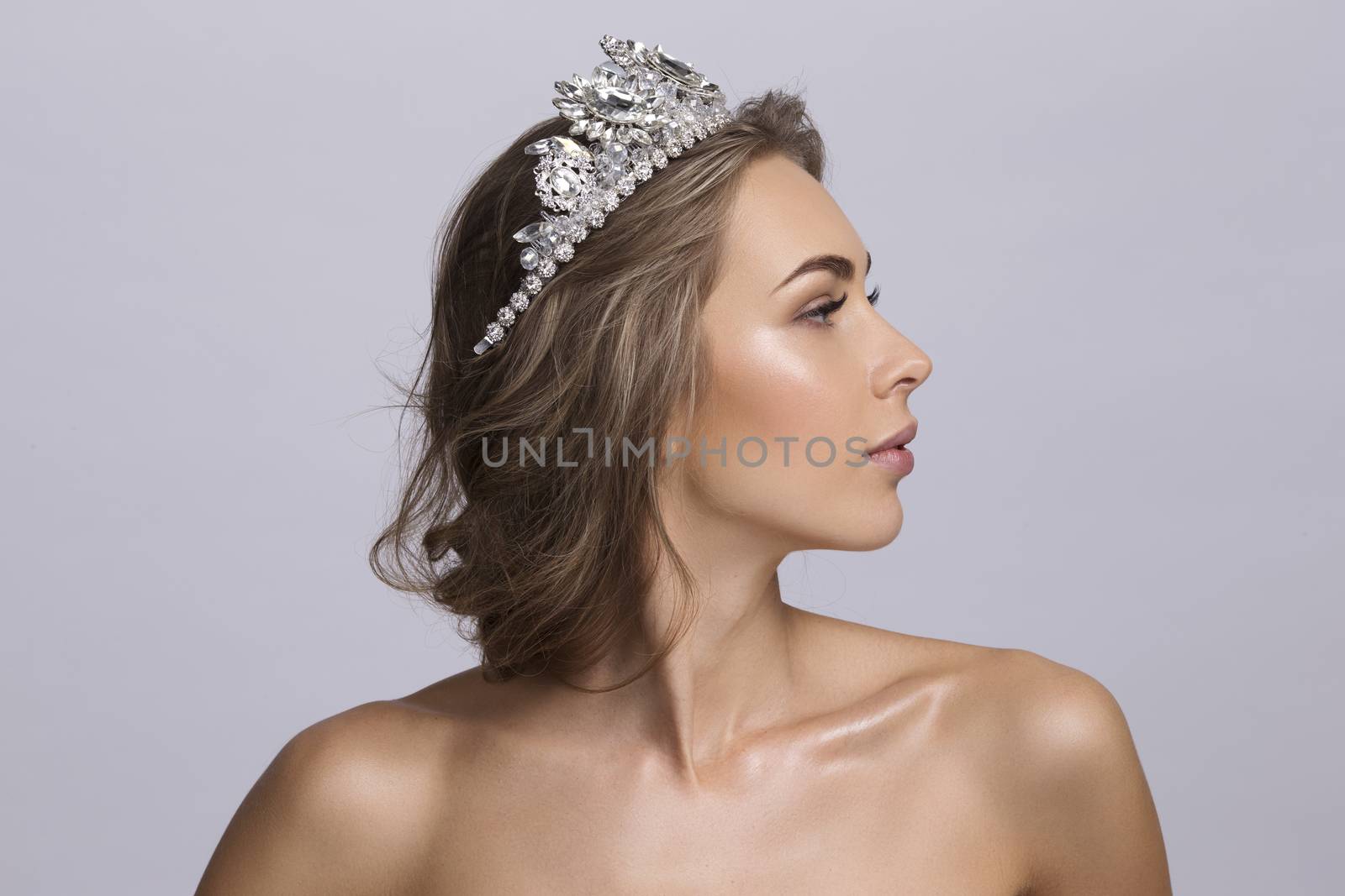 Portrait of beautiful young blonde woman with a diadem on a head