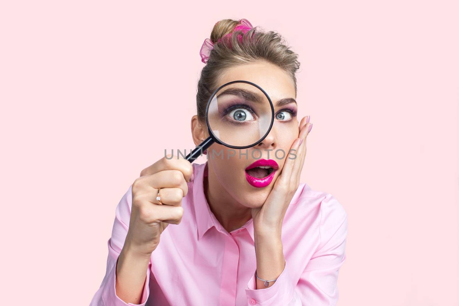 Woman looking through magnifying glass by ALotOfPeople