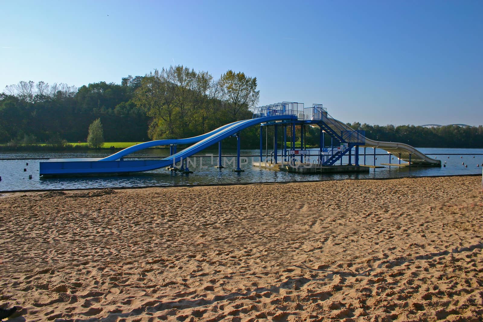 Blue Swimming sledges in a lake close to the beach