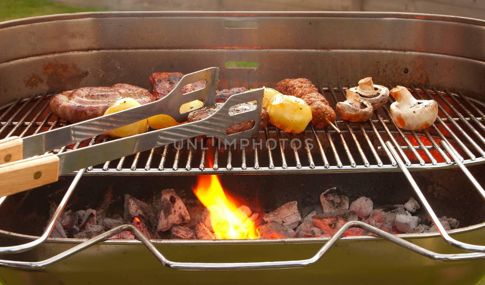 Cooking tastetful meat on a barbecue outside in the garden