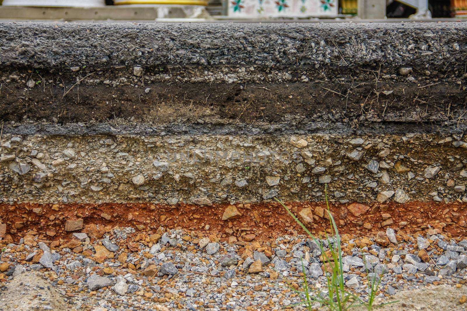 construction of black asphalt layer road with soil and stone