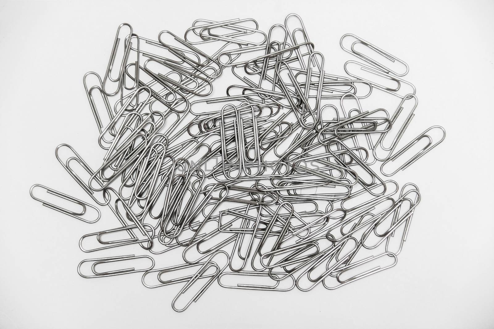 many metal stainless clips on white background