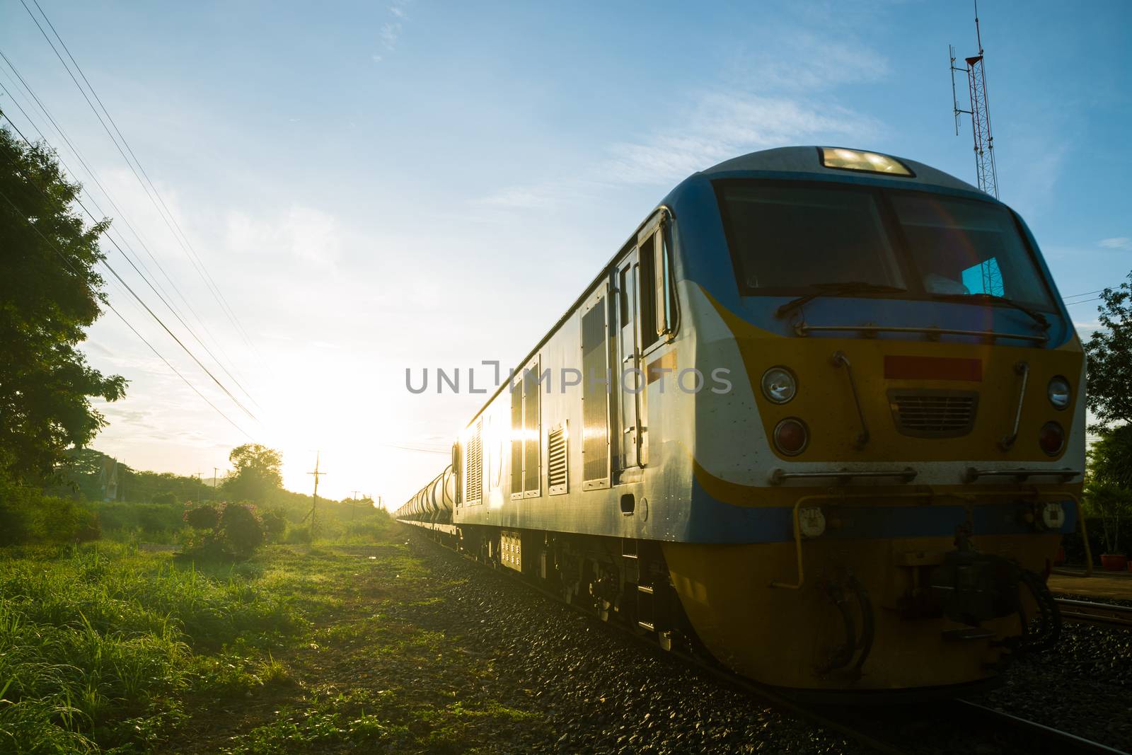 Old Train on Railway Track in morning sunshine with Rural Scene