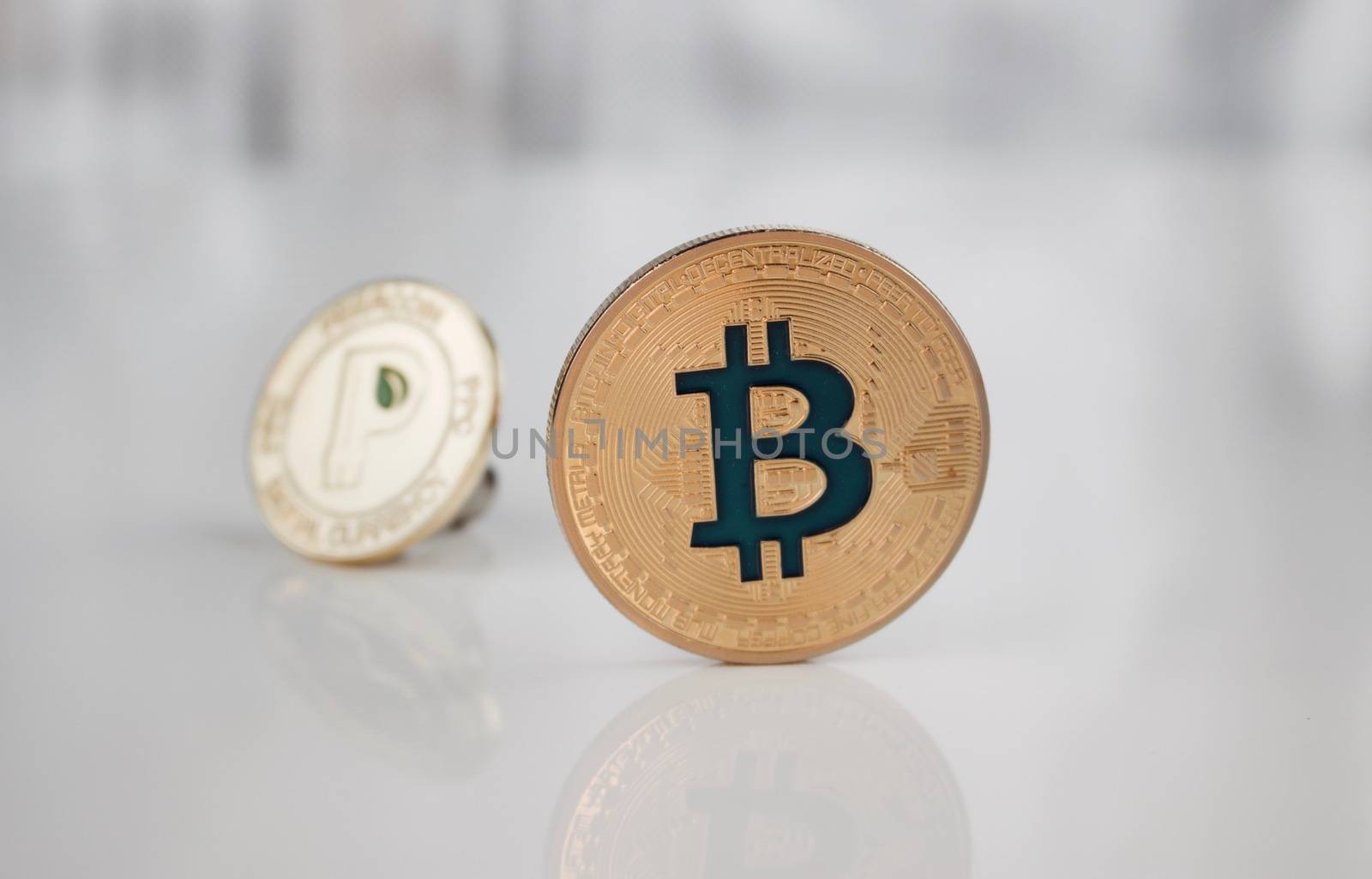 Cryptocurrency physical gold bitcoin coin and gold peercoin coin.