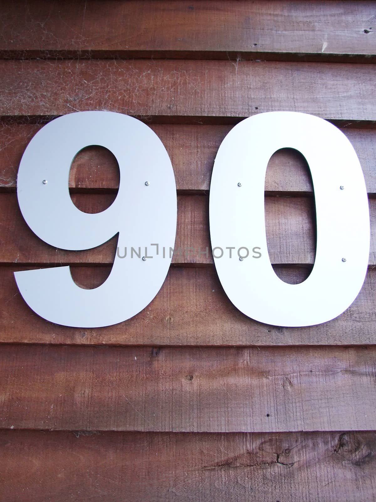 Senior man concept : House number ninety sign on wooden background