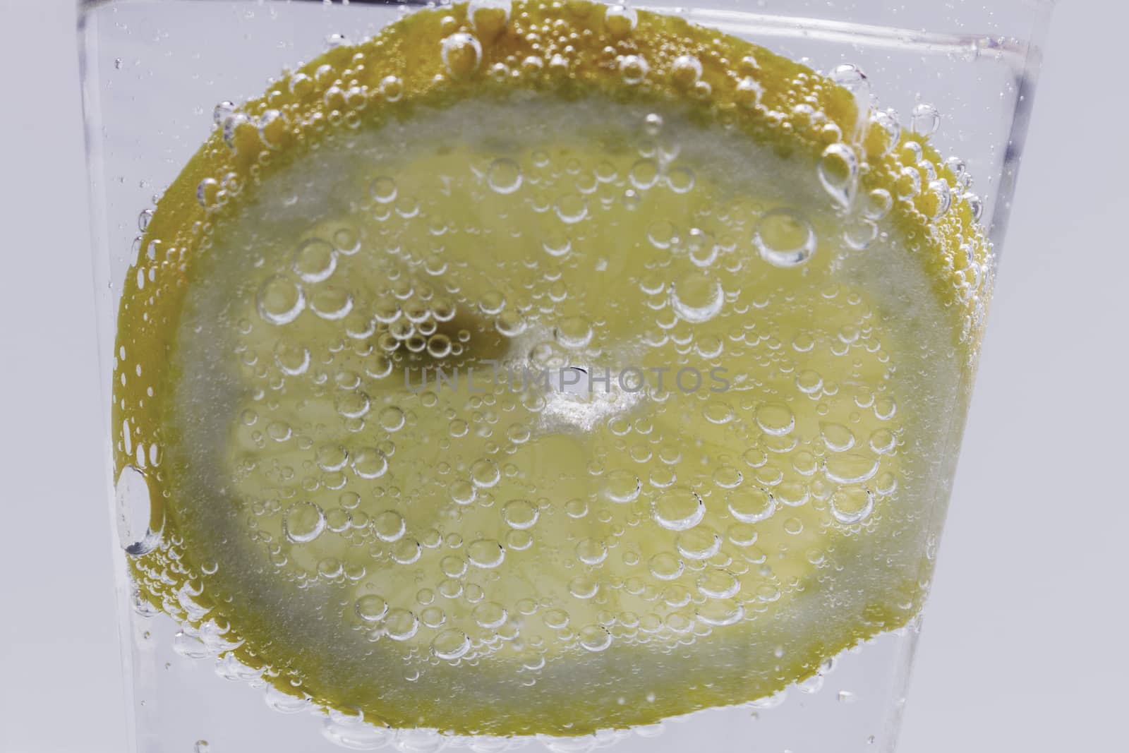 Lemon Slice In Water With Air Bubbles