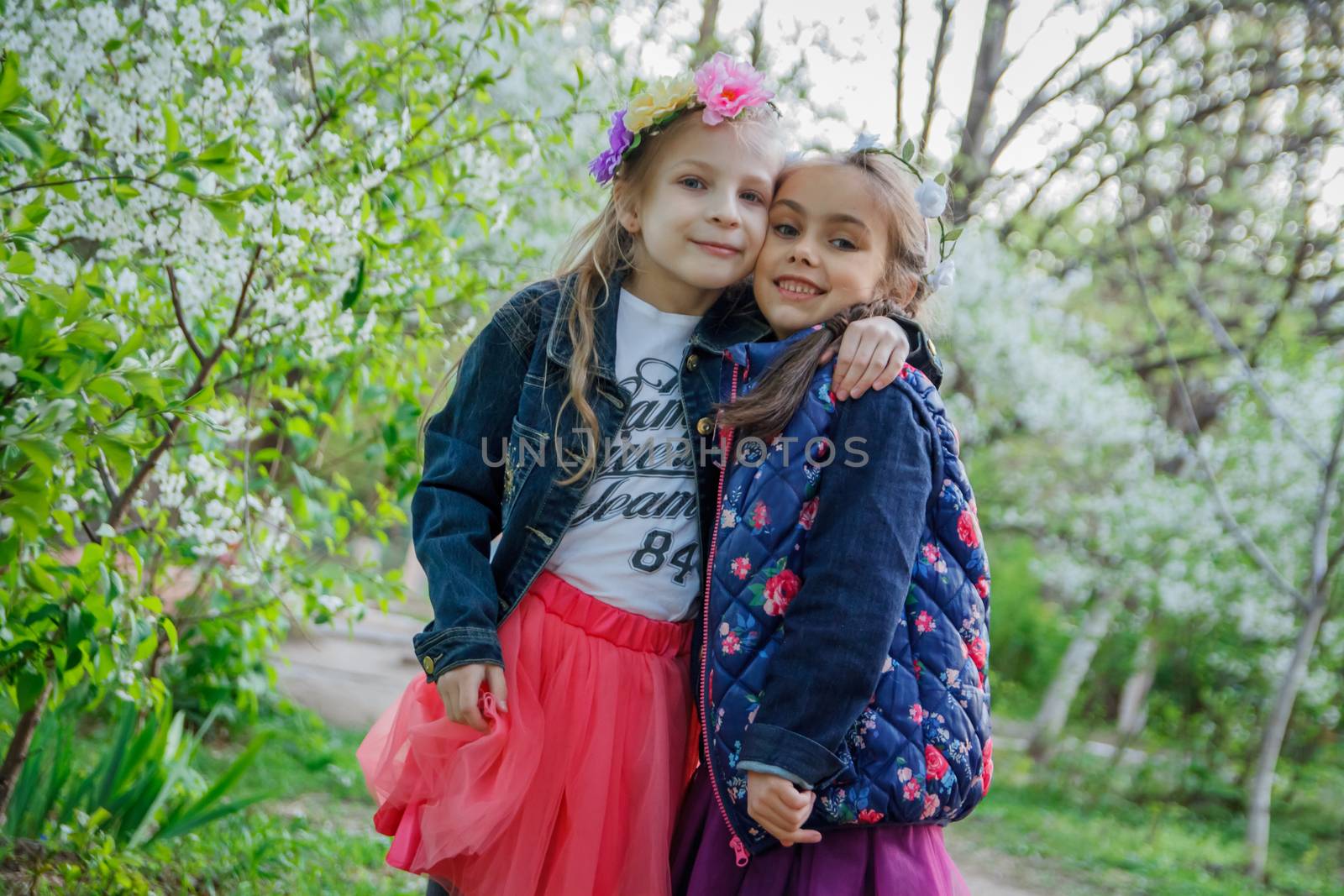 Two happy girls enjoying spring garden