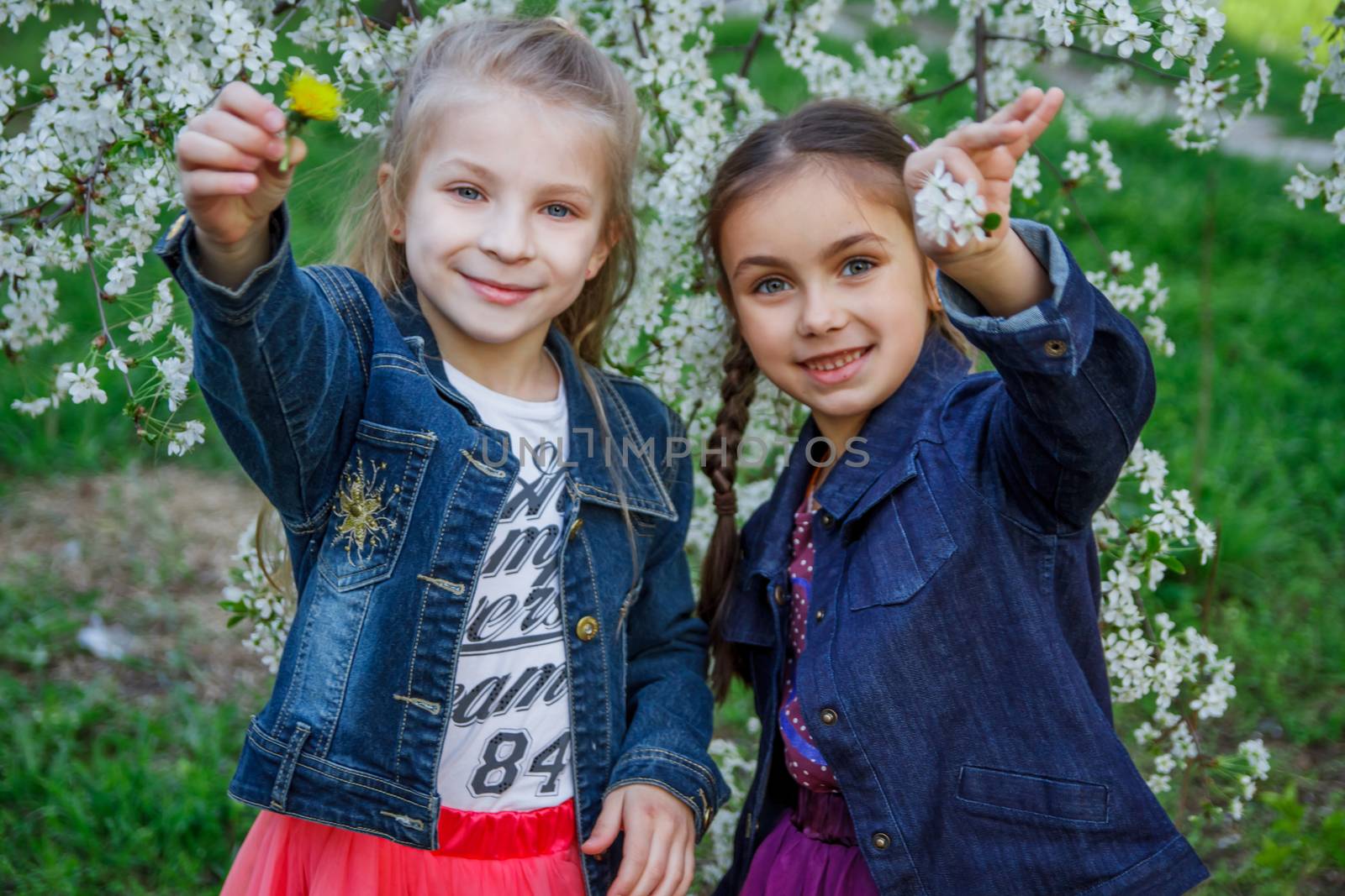 Two happy girls enjoying spring garden