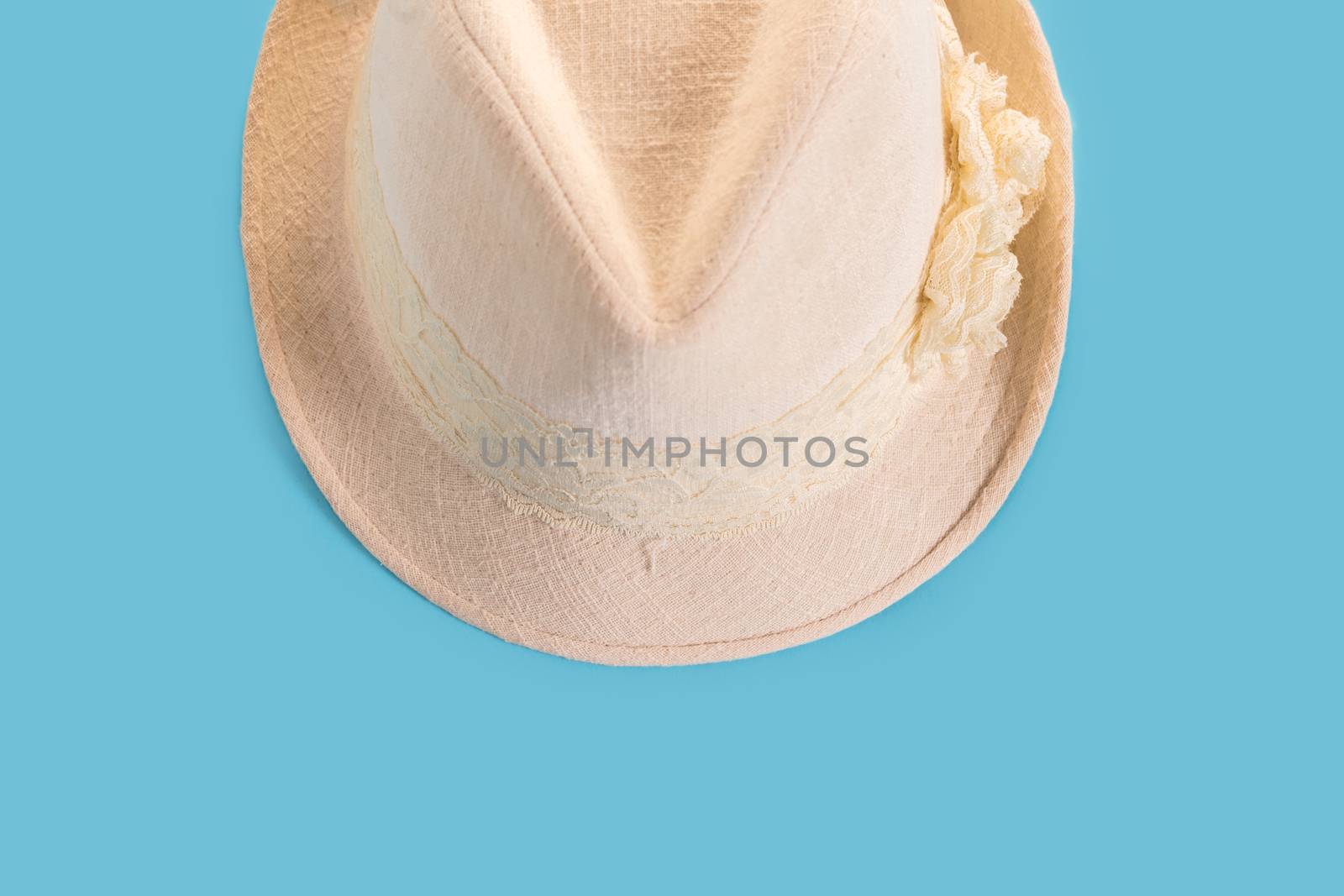 Summer woman's hat close-up on a blue background
