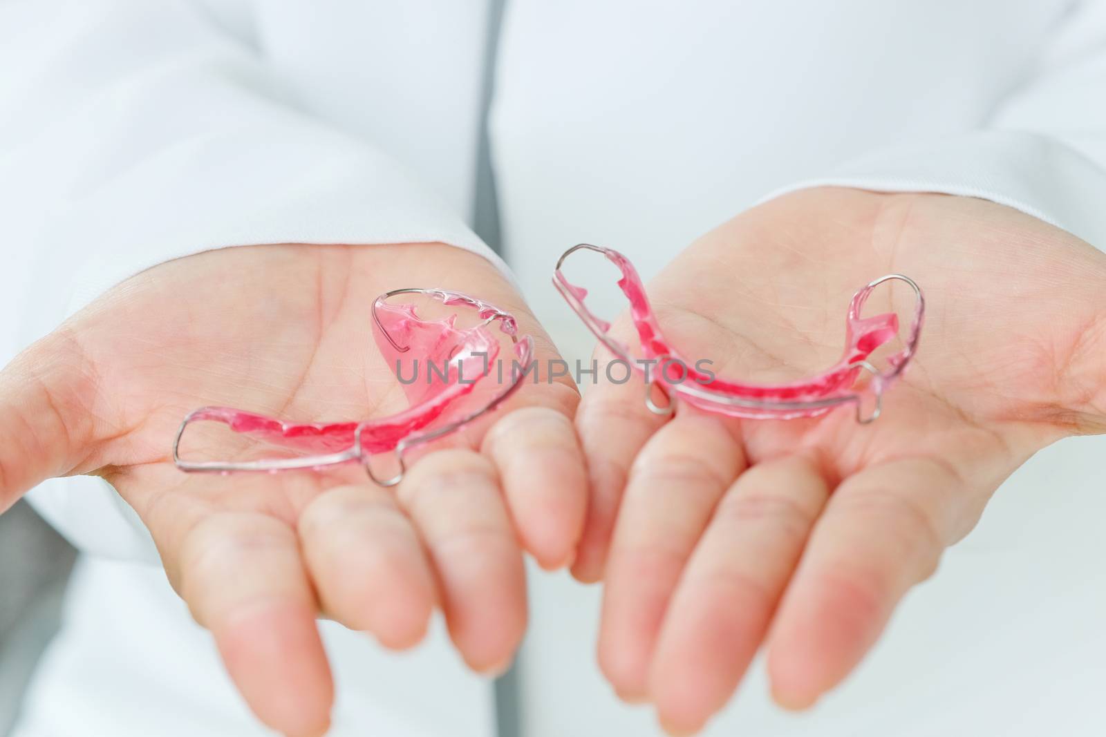 Dentist holding Retainer, Orthodontics Dental concept background