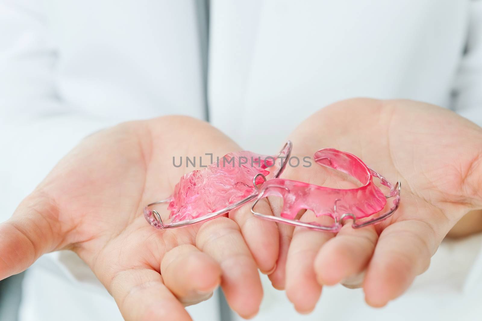 Dentist holding Retainer, Orthodontics Dental concept background