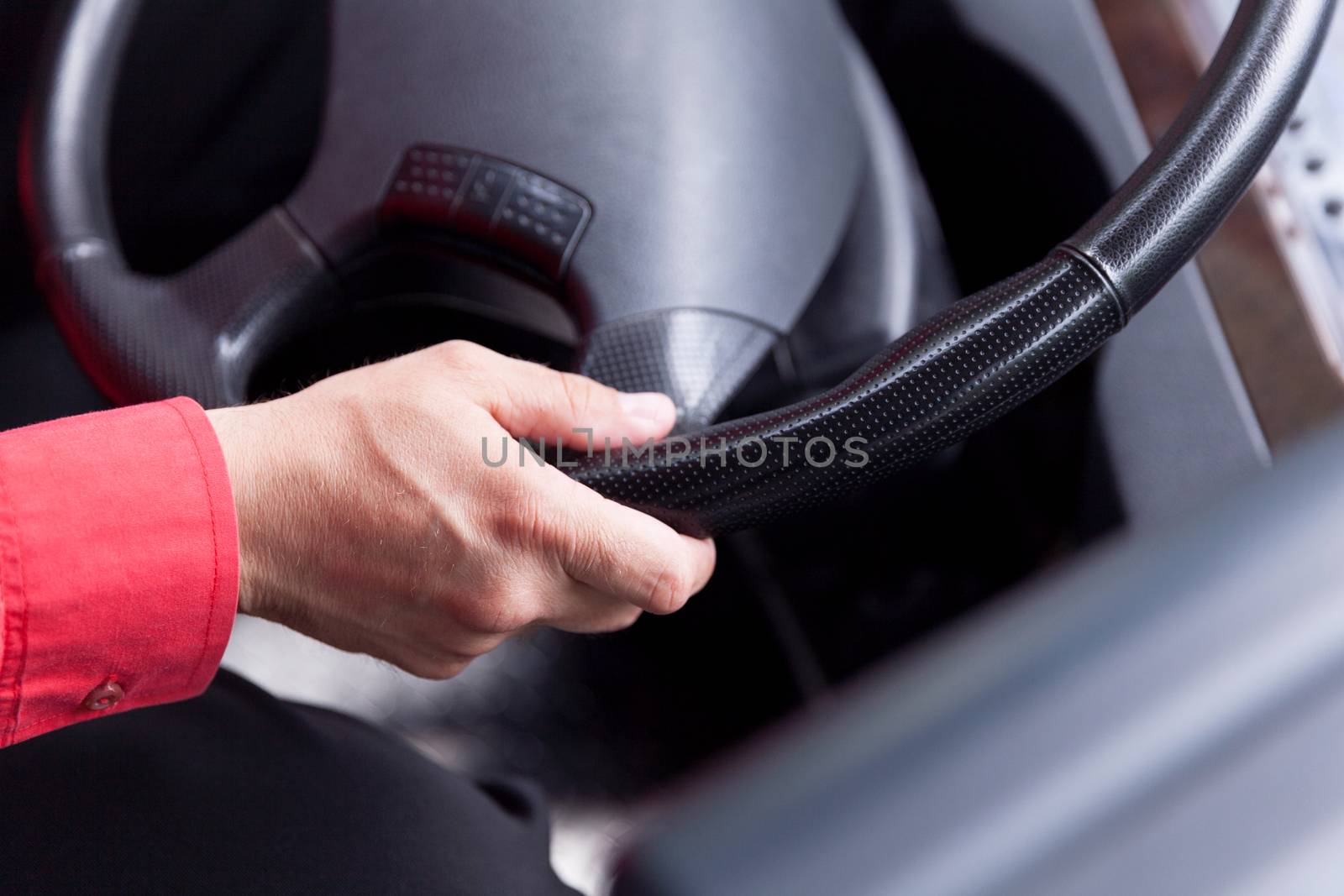 Hand close up of bus driver driving passenger bus