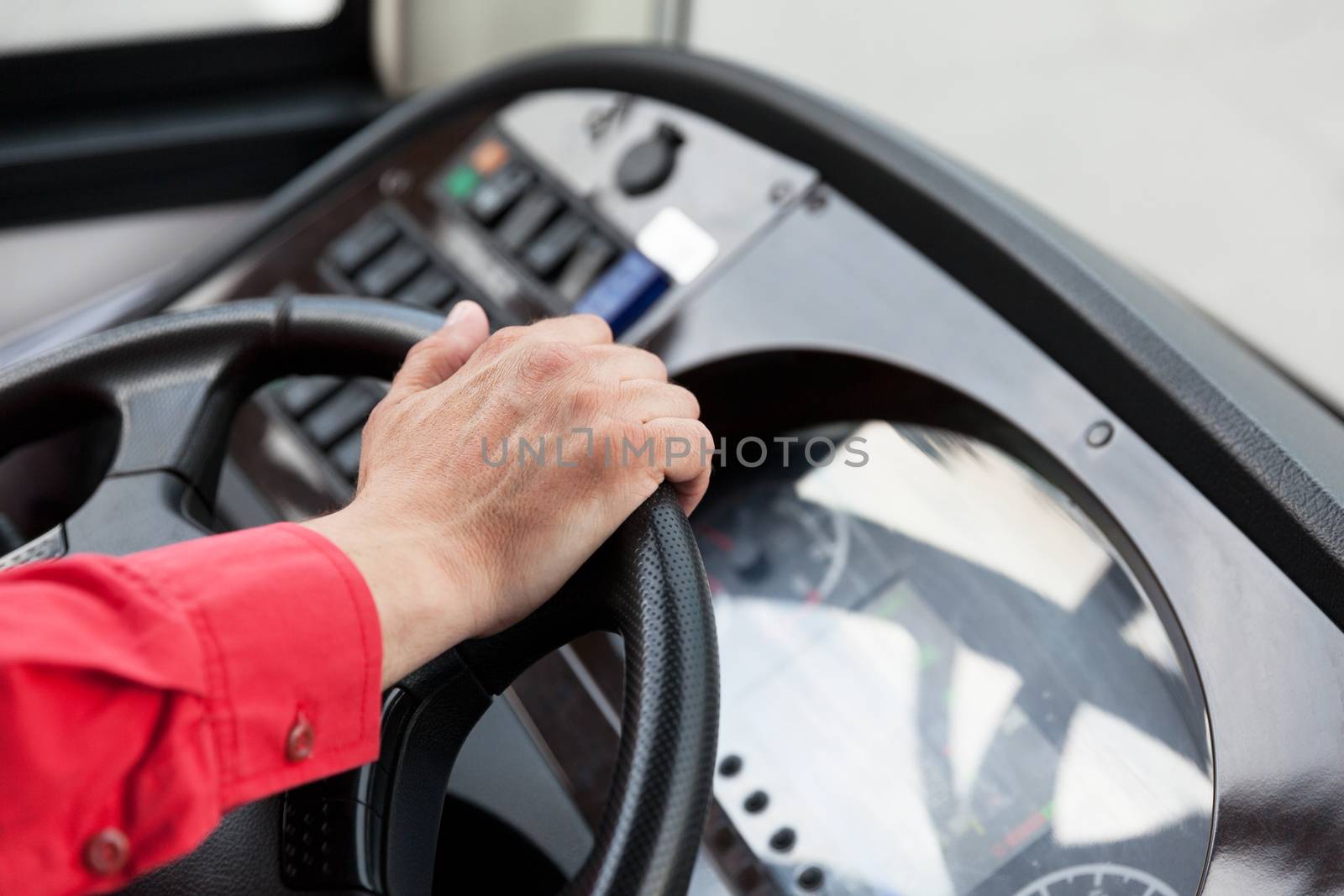 Hand close up of couch driver driving passenger bus