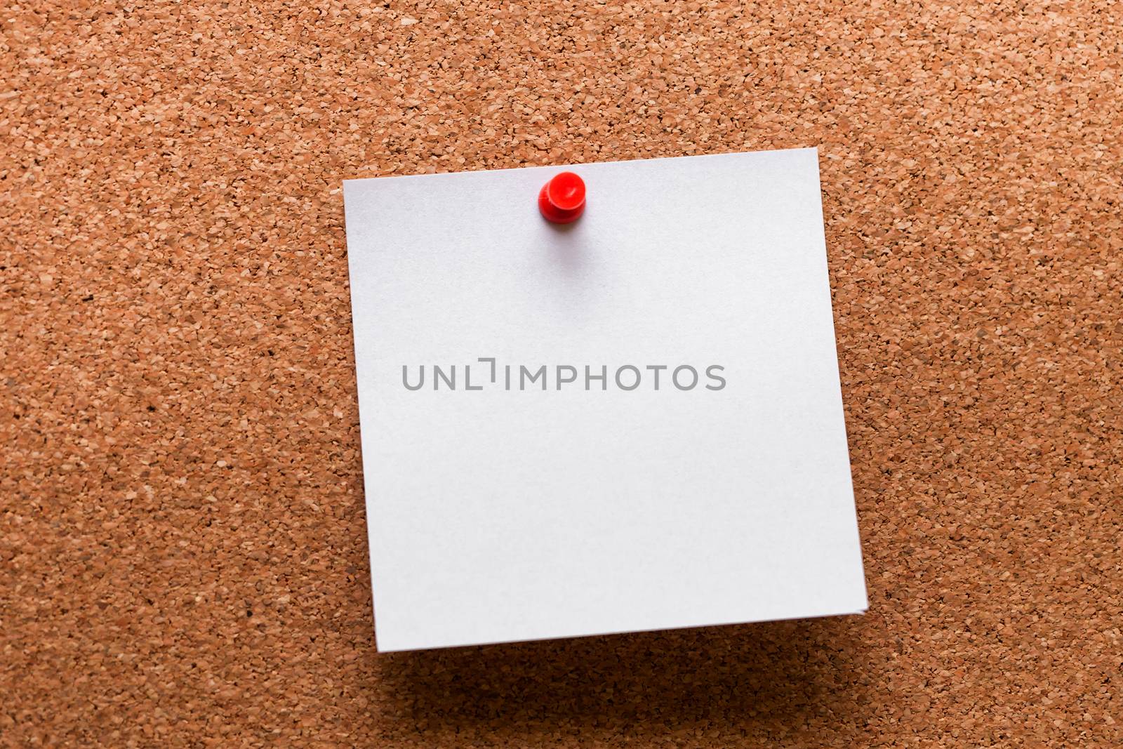 White paper with red clip nailed on wooden board by nopparats