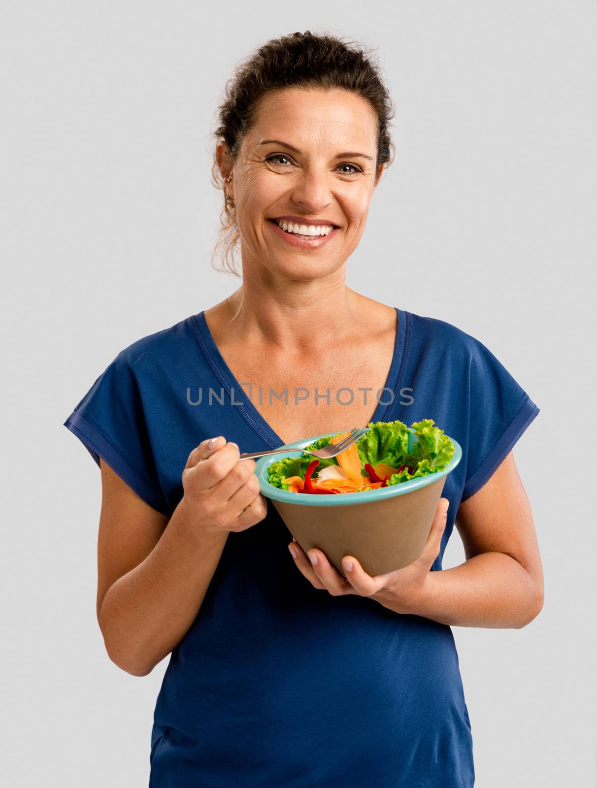 Portrait of a middle aged woman eating a healthy salade
