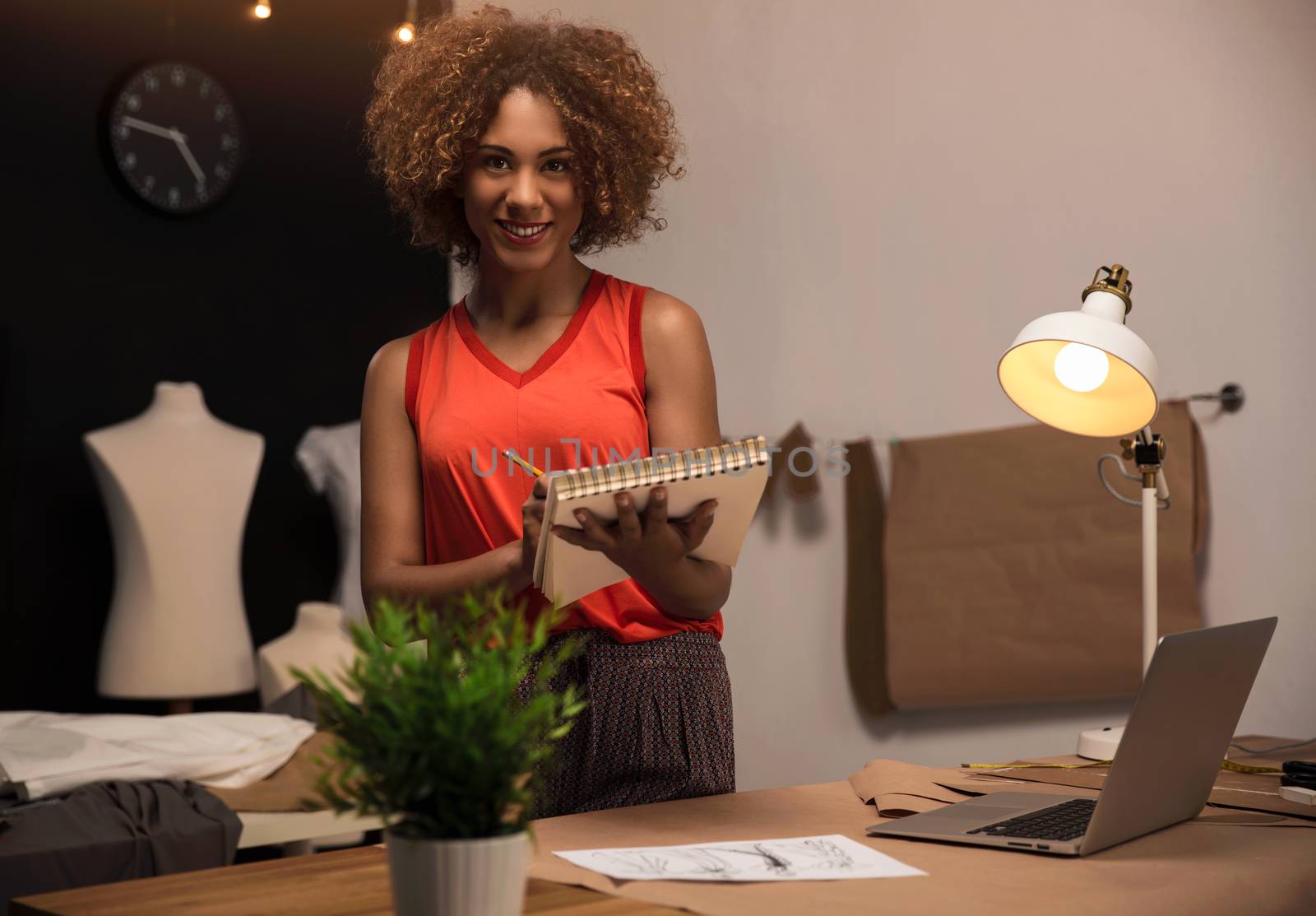 A young fashion designer working on her atelier