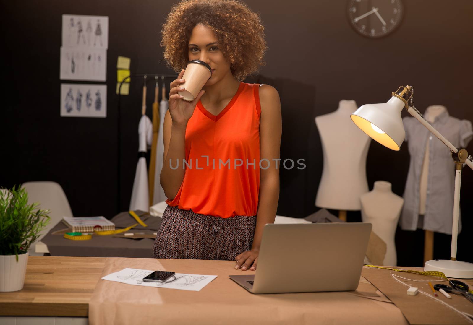 A young fashion designer working on her atelier