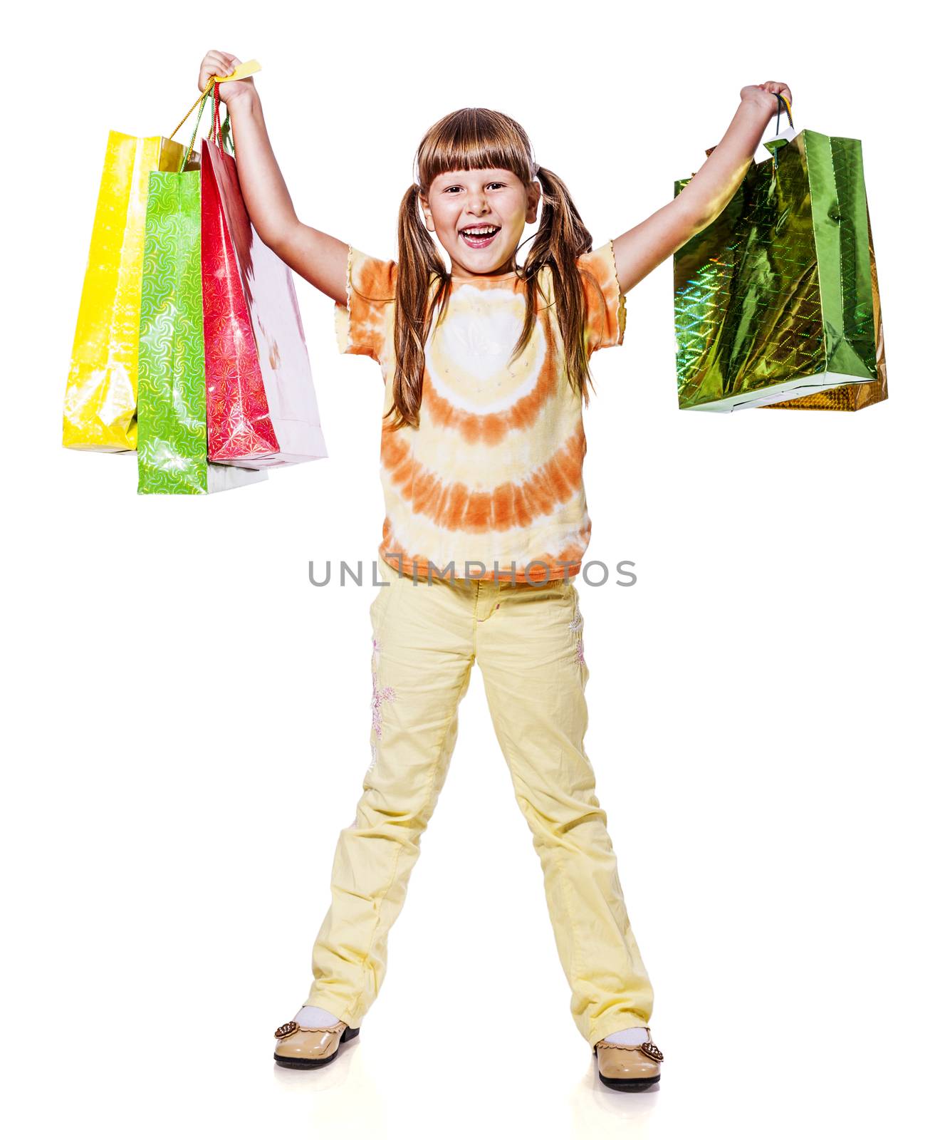 Smiling six years Girl holding presents bags isolated