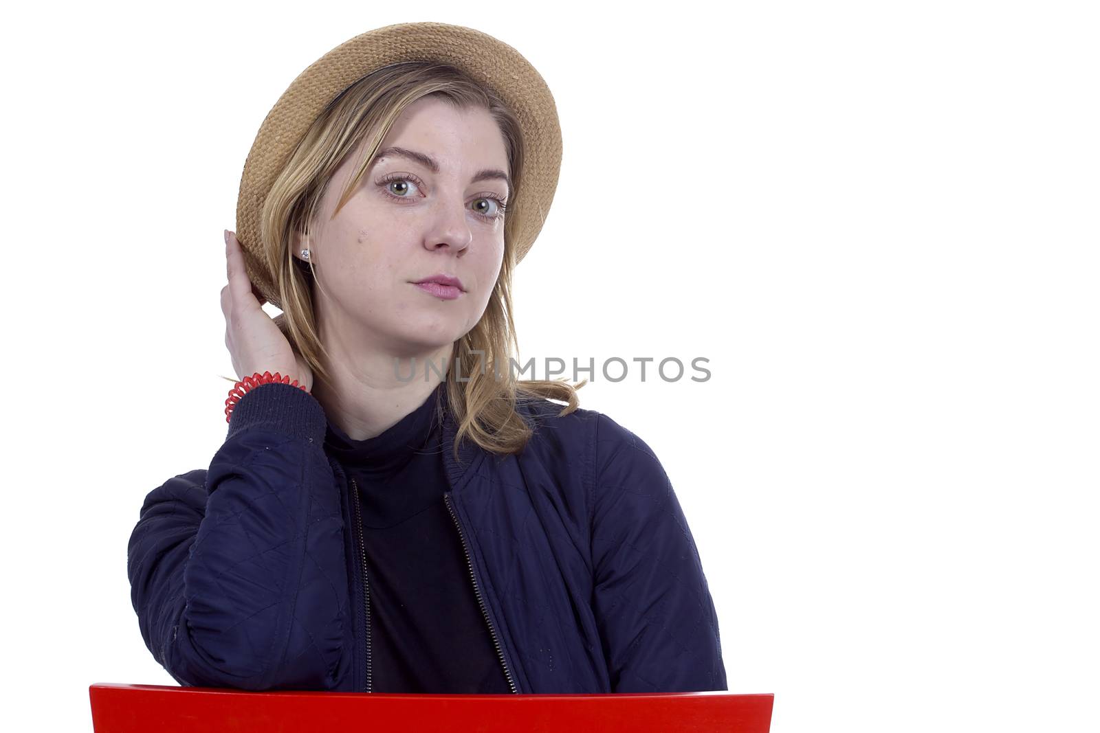 Portrait of a young blonde woman in a straw hat