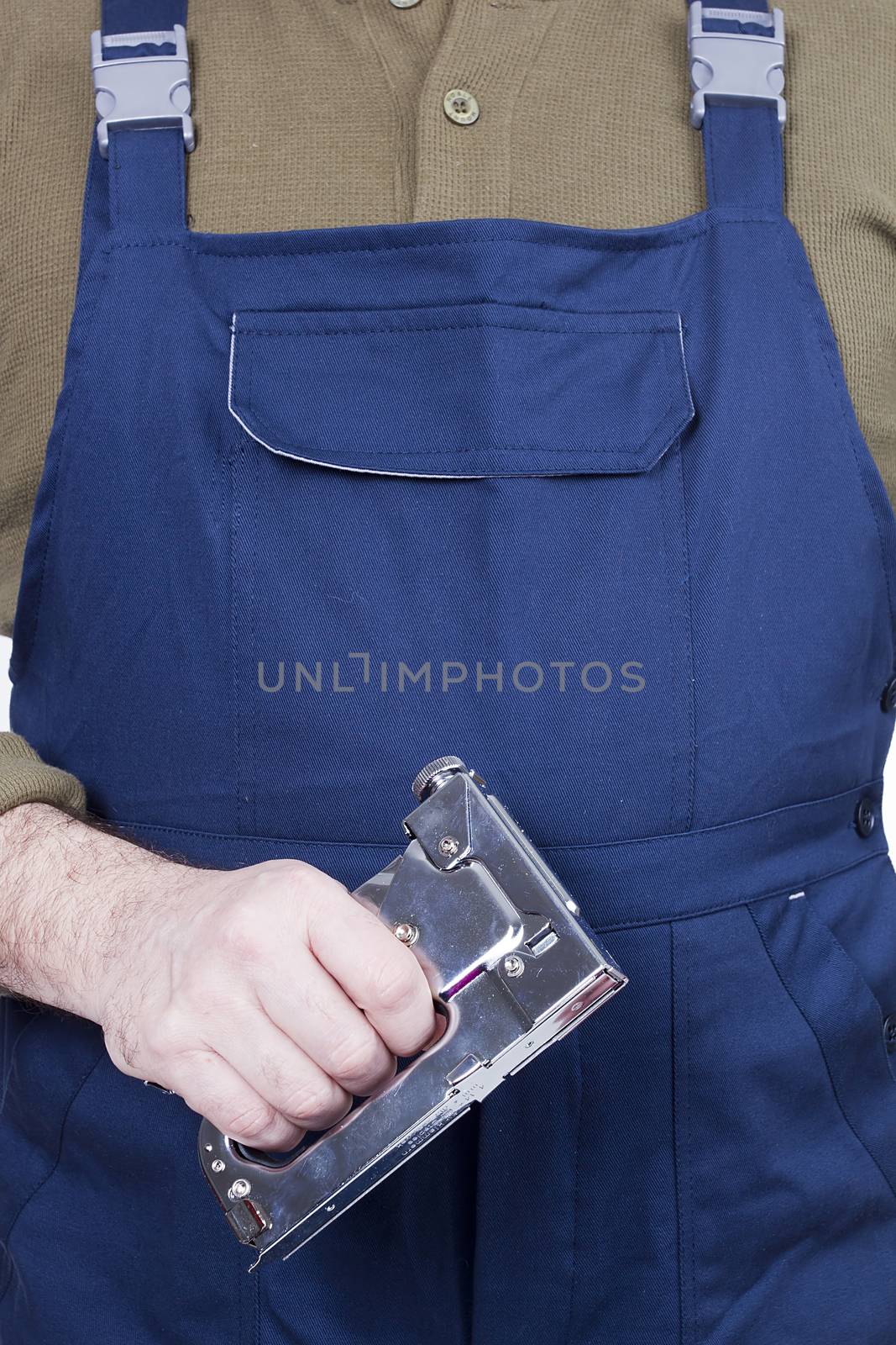 Construction stapler in the hands of a worker on a white background