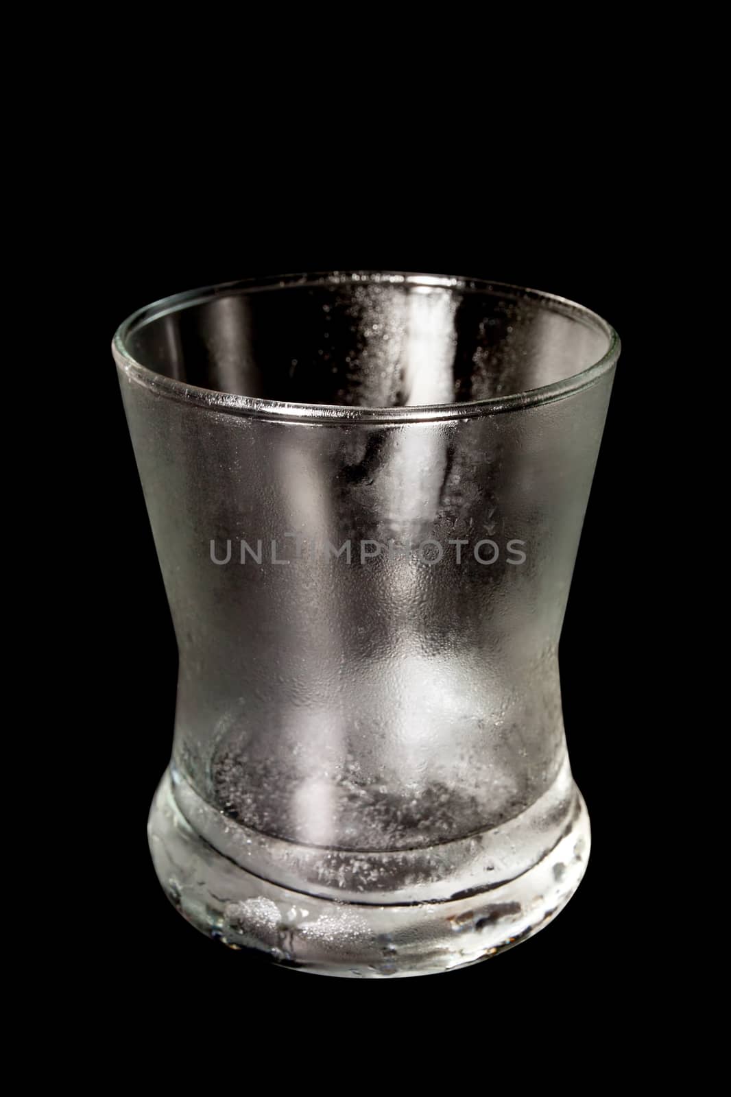 Empty glass is cool. Water drops by side the glass. Isolated On Black objects with clipping paths