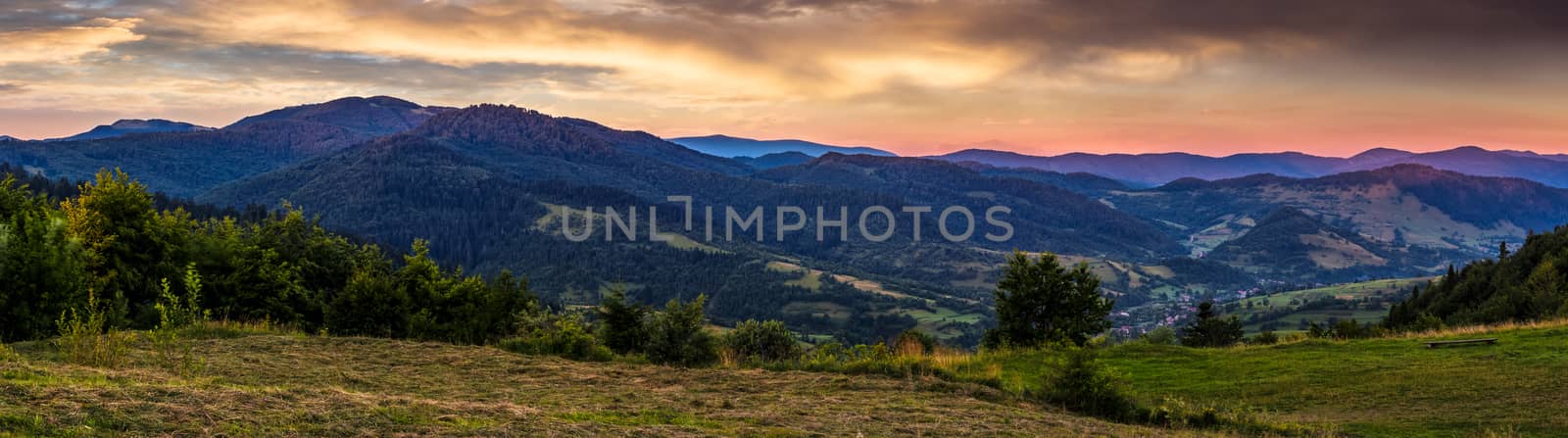 panoramic countryside landscape at sunrise. village in valley, view from the hill