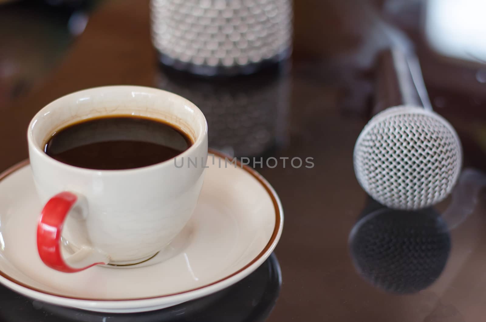 Cup of hot coffee in music  on black  background