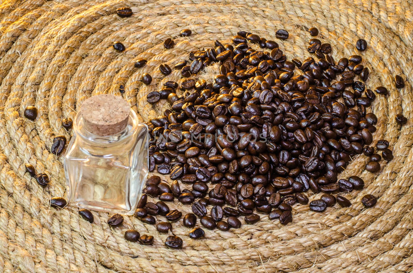 Glass jar with coffee beans on a jute rope. by metal22