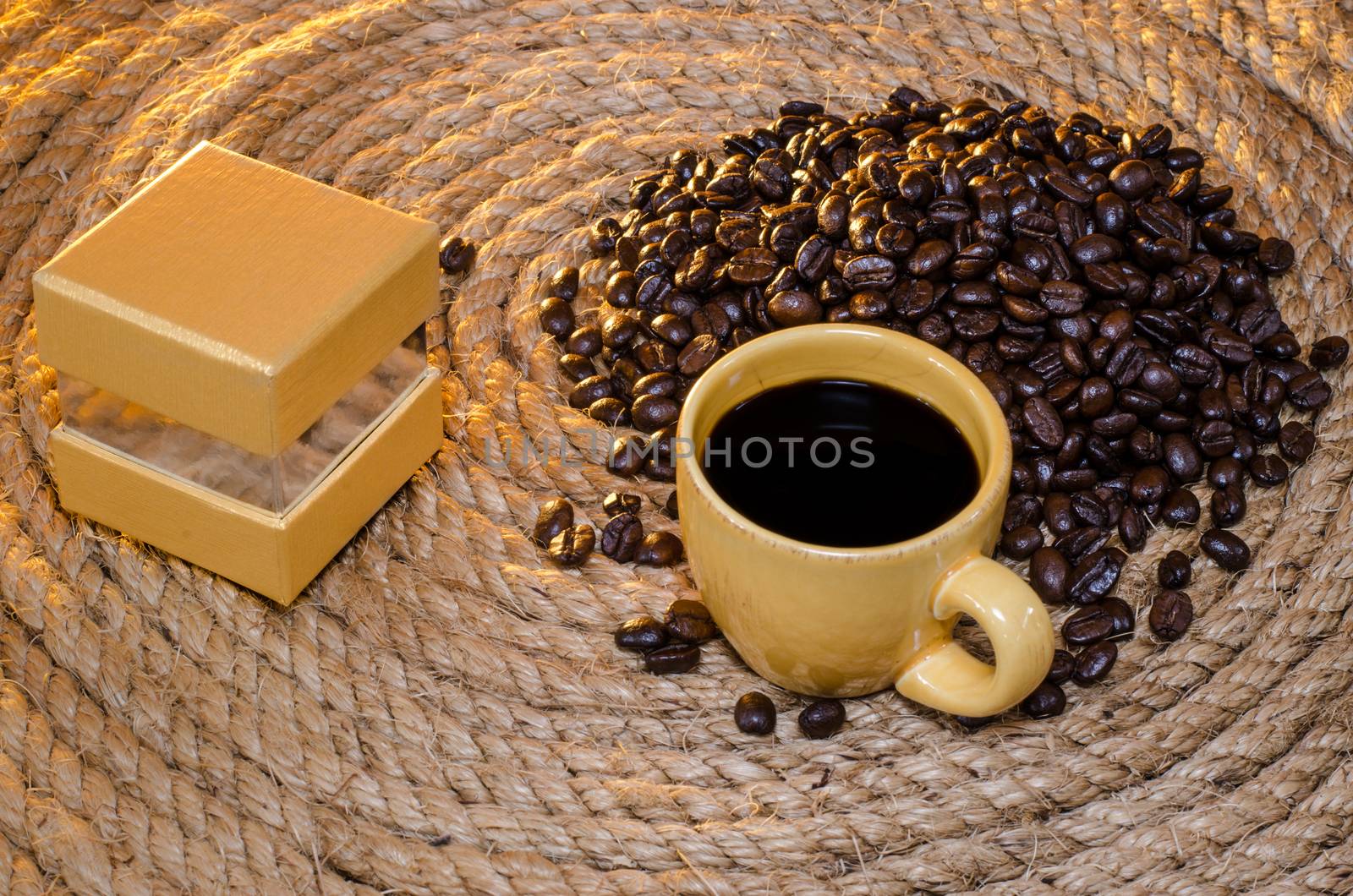 Cup of coffee with box gold Square on a jute rope.